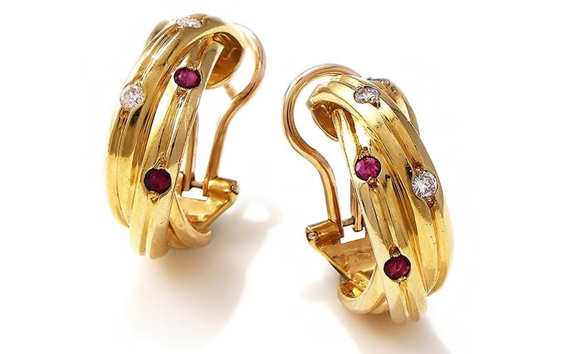 Inline Image - Cartier, a pair of gem set 'trinity' earrings designed as three interlocking reeded 18ct gold bands | Sold for £3,024