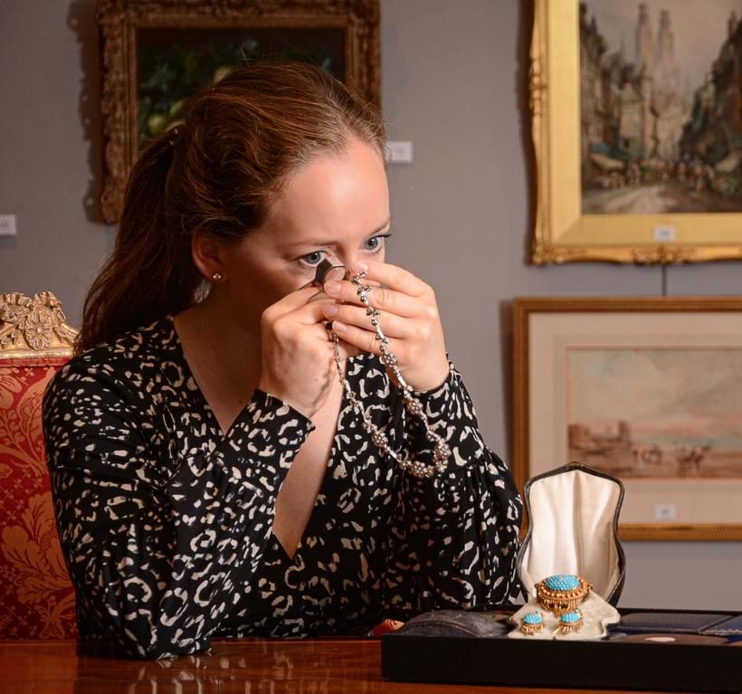 Inline Image - Alexandra Francis, one of Dreweatts three qualified gemologists inspects a necklace