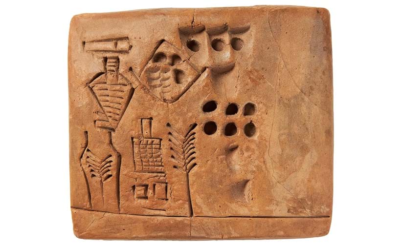 Inline Image - Lot 3: The Kushim Clay Tablet, a large and remarkably fine pictographic tablet recording beer production at the brewery at the Inanna Temple in Uruk, with the apparent personal name 'Kush-im', that perhaps the first attested personal name in history, clay tablet with pictographic inscription, [Sumer (Uruk), Uruk III period (thirty-first century BC.)] | Est. £70,000-90,000 (+fees)